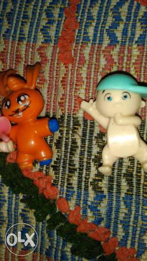 Two White And Orange Plastic Toys