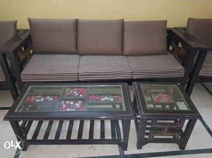 5 seater wooden sofa with a centre table and a