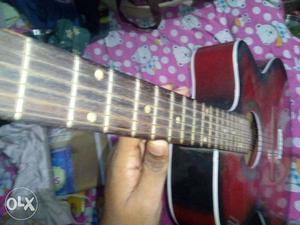 Red and black guitar onoy 2 months old with extra