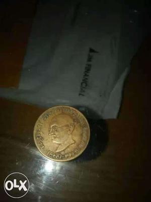 Round Gold-colored Mahatma Gandhi Coin