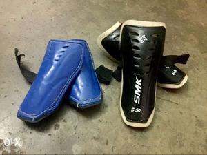 Two Blue And Black Shin Guards