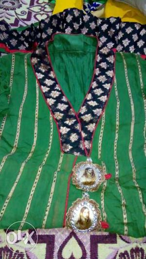 Green frock suit with heavy embroidery.. it is