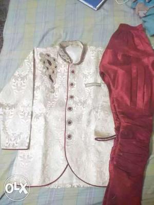 New golden sherwani with maroon balloon pant for