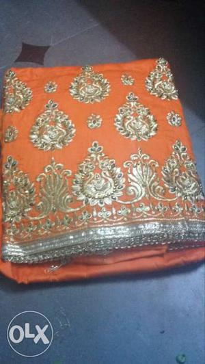 Orange And Silver Floral Textile