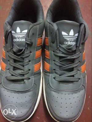 Pair Of Gray With Orange Stripes Adidas Sneakers