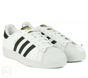 Pair Of White Adidas Superstar Sneakers