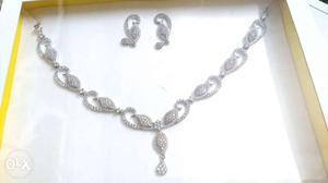 Silver covering necklace with white stones and matching