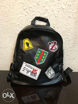 Black, Yellow, Green, White, And Red Leather Backpack
