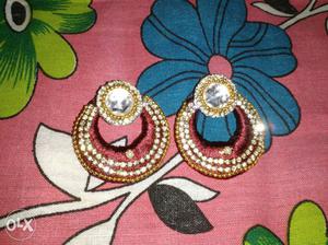 It is maroon silk based earring finished by stone