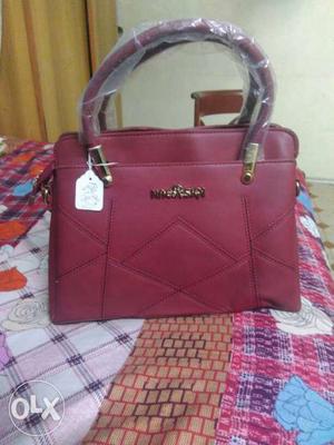 New unused hand purse in maroon colour of NAERSIQI
