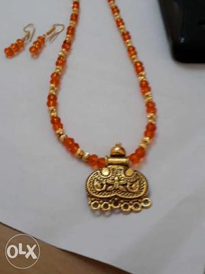 Orange crystals and artificial gold beads with