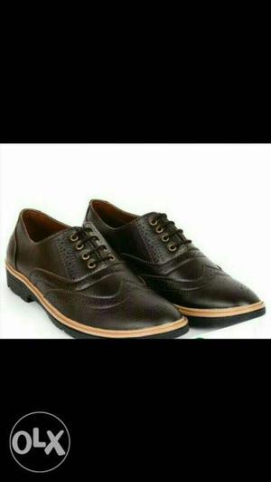 Pair Of Black Wingtip Leather Dress Shoes