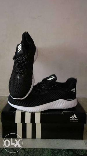 Pair Of Black-and-white Adidas Alpha Bounce Sneakers With
