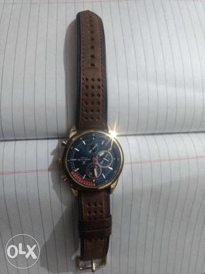 Round Gold Chronograph Watch With Black Leather Strap