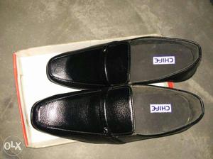 Pair Of Black Leather Penny Loafers