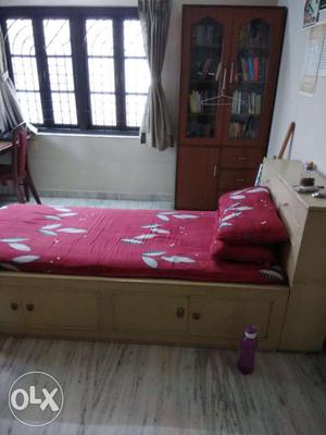 Brown Wooden Bed With White And Red Floral Mattress