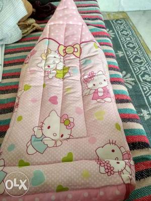 Baby sleeping bag, pink in colour.