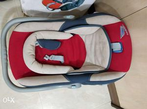 Baby's Beige And Red Car Seat Carrier
