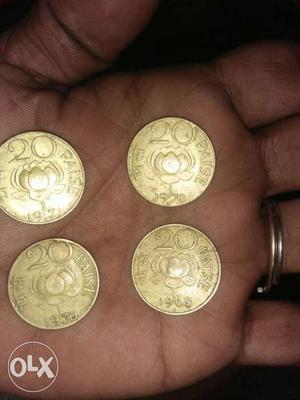 Four Gold-colored 20 Indian Paise Coins