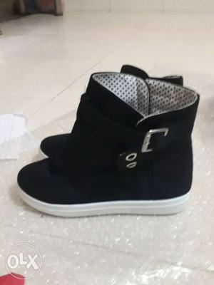 Girl's Pair Of Black And White Boots