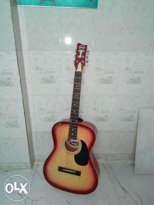 Red And Beige Acoustic Guitar