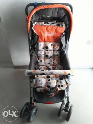 Baby's Orange And White Stroller