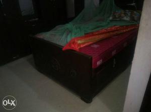 Black Wooden Bed Frame With Red Bed Mattress