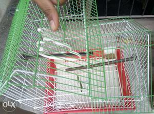 Green, Red, And White Metal Pet Cage