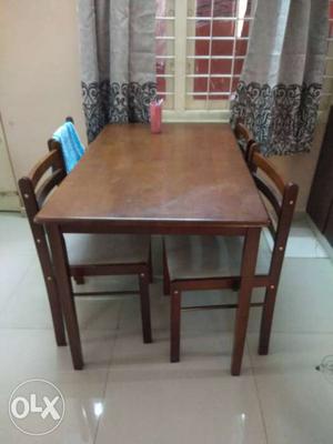 A 4 seater rubber wood dining table. it is less
