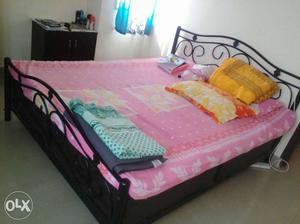 Black Wrought Iron Panel Bed With Pink Floral Bedspread