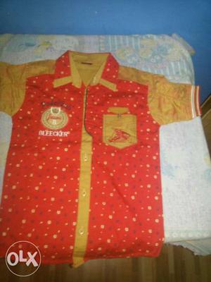Red and yellow shirt in new looking condition size kids 30