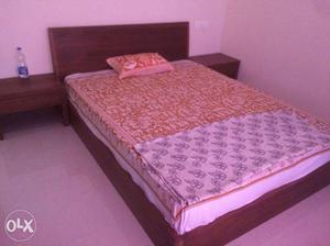 Brown Wooden Bed Frame With White And Black Mattress