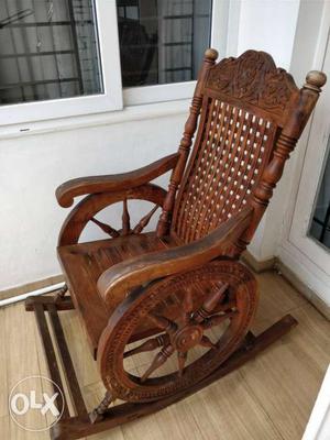 Wooden rocking chair with intricate designs in
