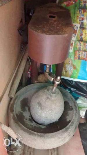 Stone grinder with coconut grator on top in good working