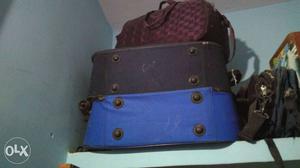 Two Black And Blue Soft Shell Luggages