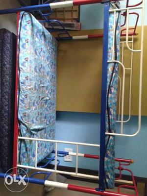 White, Red, And Blue Metal Bunk Bed without beds