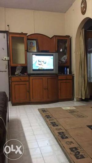 Brown Wooden TV Hutch With Flat Screen Television