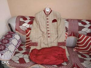Manyavar sherwani with golden red colour and a