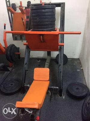 Orange nd black Leg Press and hack squat machine capsul pipe