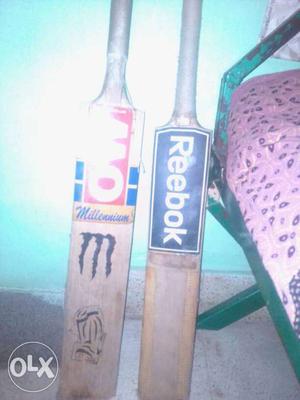 Two Brown-and-blue Reebok Cricket Bats