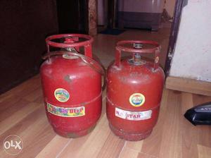 Two Red small Propane gas cyliner Tanks