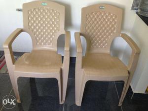 2 beige colored plastic chairs