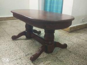 Wooden centre table. Oval shape. Carved legs.