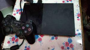 Black sony ps2 with 2 controllers and 2 games,