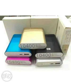 Five White, Blue, Pink, Gold, And Black Xiaomi Powerbanks