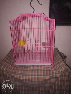Pink coloured regular sized bird cage