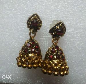 Pair Of Gold-colored Ruby Jhumka Earrings