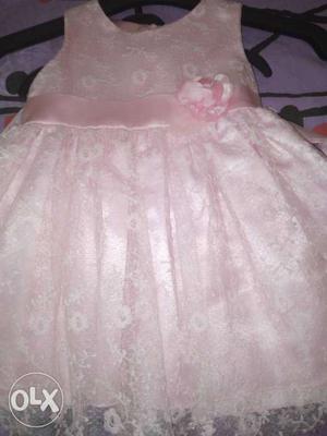 It's a Disney brand pink frock for 14 to 24months