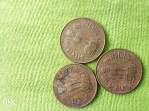 Three Round Gold-colored Indian Coins