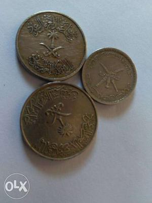 Three Round Silver-colored Arabic Coins